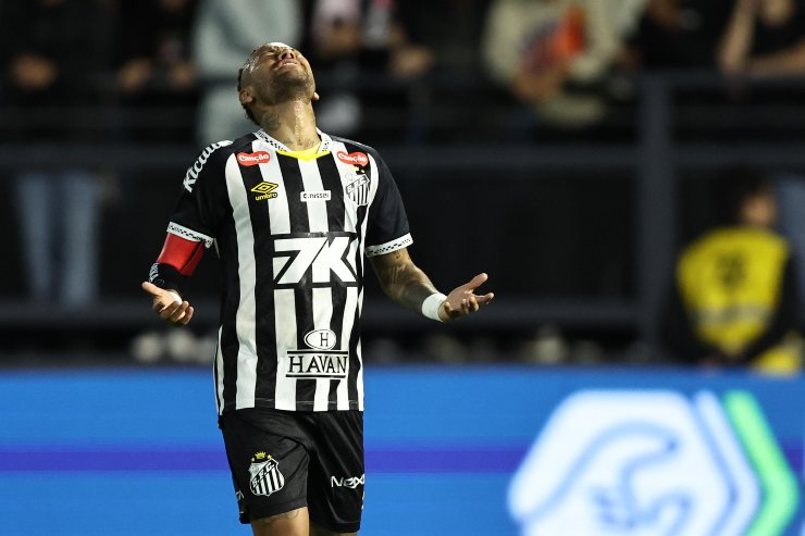 Neymar con la maglia del Santos 2025 durante una partita del campionato brasiliano, ritratto mentre alza le braccia in segno di frustrazione.